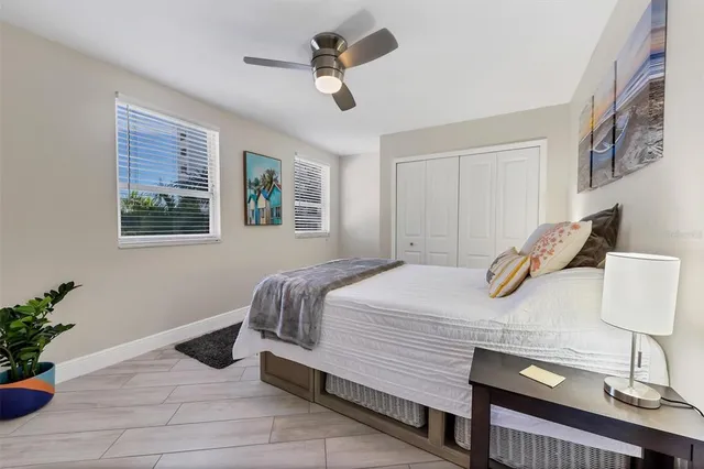a bedroom with a bed potted plant with the wooden floor