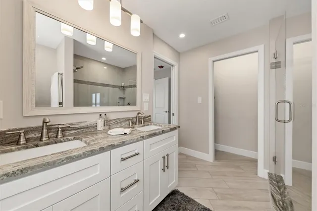 a spacious bathroom with a granite countertop sink mirror and double
