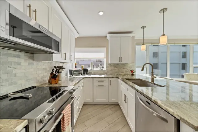 a kitchen with a sink stove and cabinets