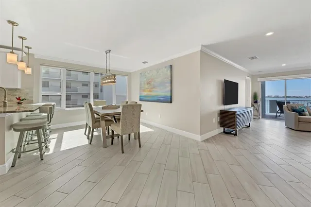 a dining room with furniture and wooden floor