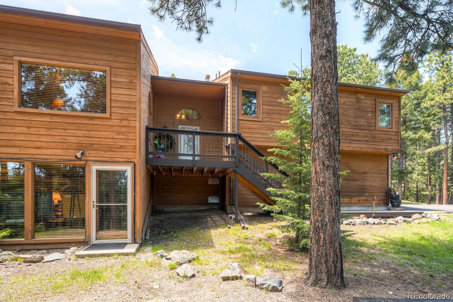 a view of a house with a small yard and wooden fence