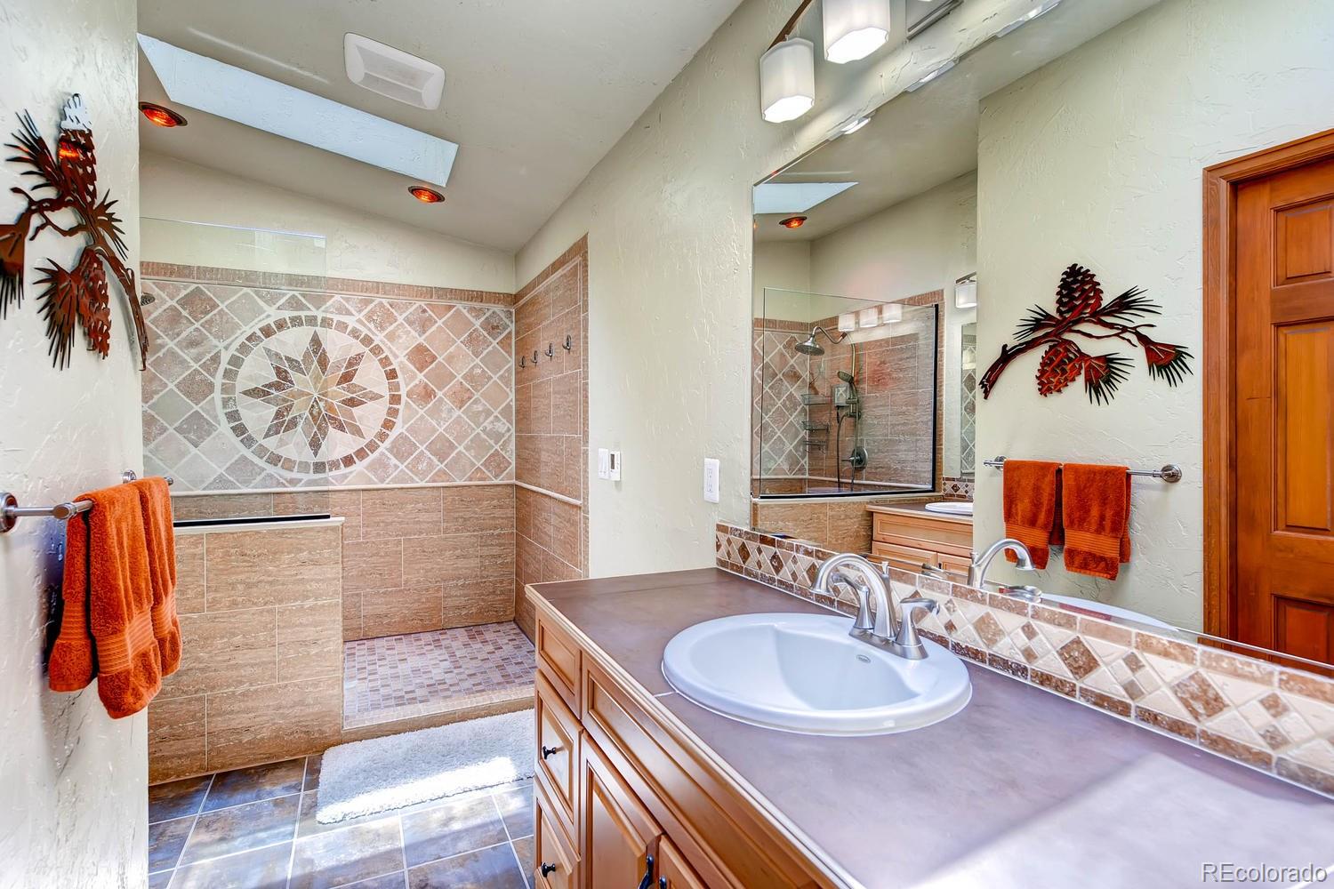 8045 Native Dancer Trail Evergreen, CO 80439 - Photo 14 of 29 a bathroom with a sink and a mirror