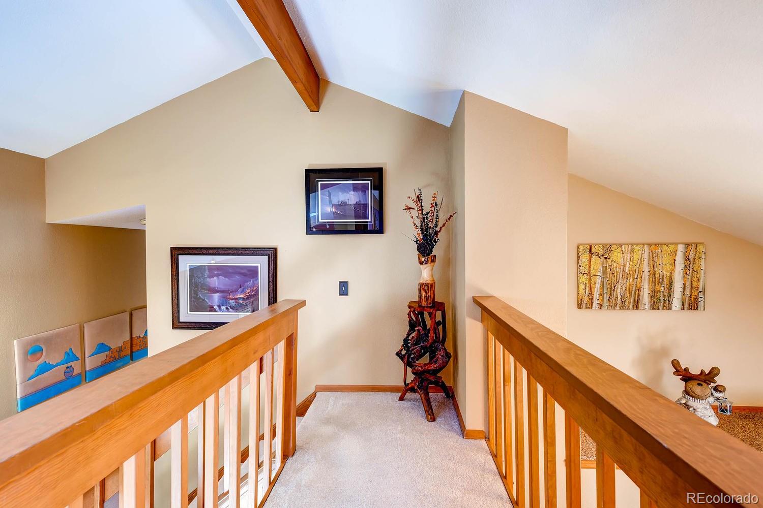 8045 Native Dancer Trail Evergreen, CO 80439 - Photo 20 of 29 a view of a hallway with windows and furniture