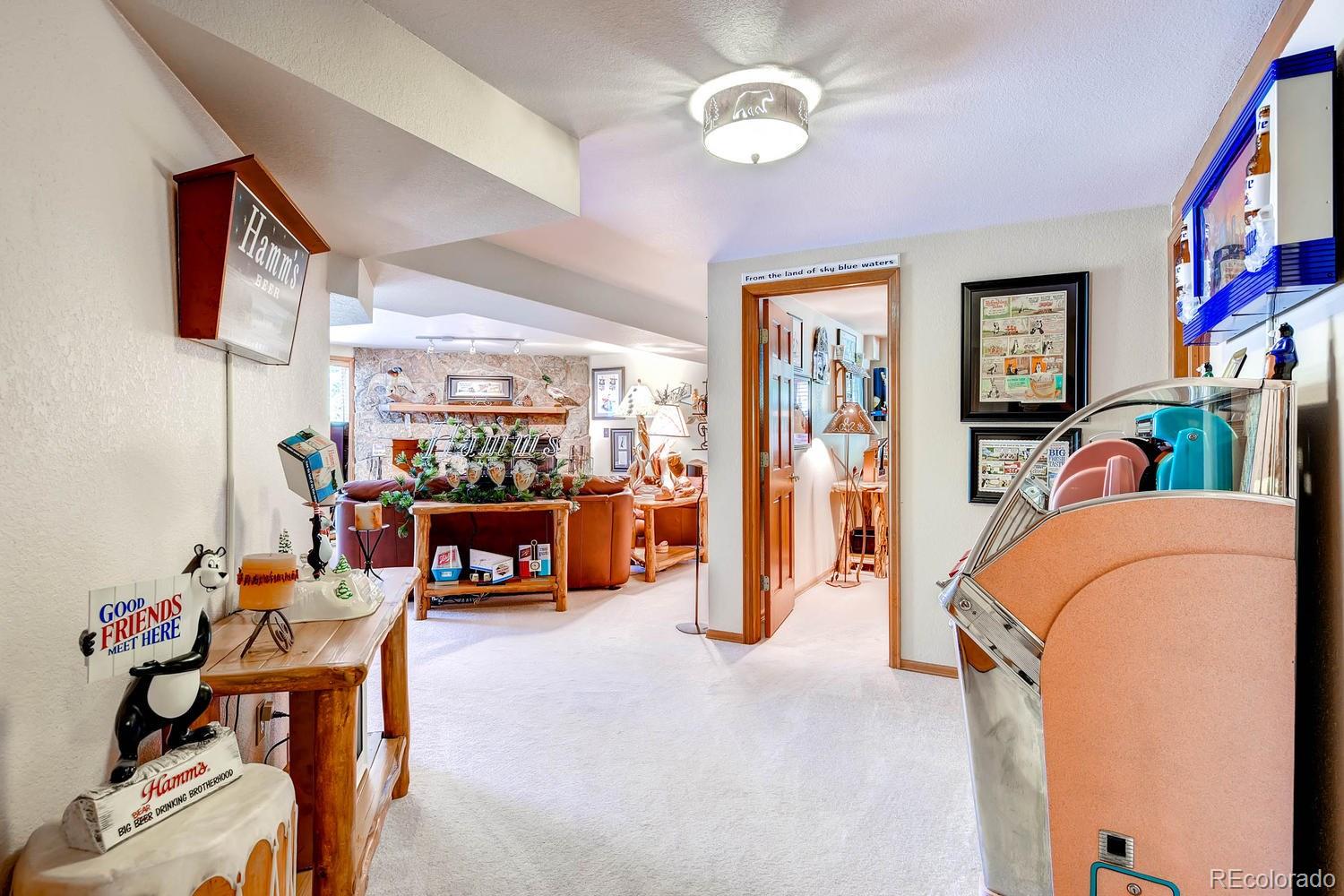 8045 Native Dancer Trail Evergreen, CO 80439 - Photo 25 of 29 a living room with furniture and a flat screen tv