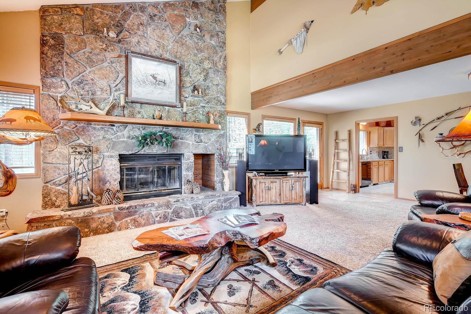8045 Native Dancer Trail Evergreen, CO 80439 - Photo 6 of 29 a living room with furniture and a fireplace