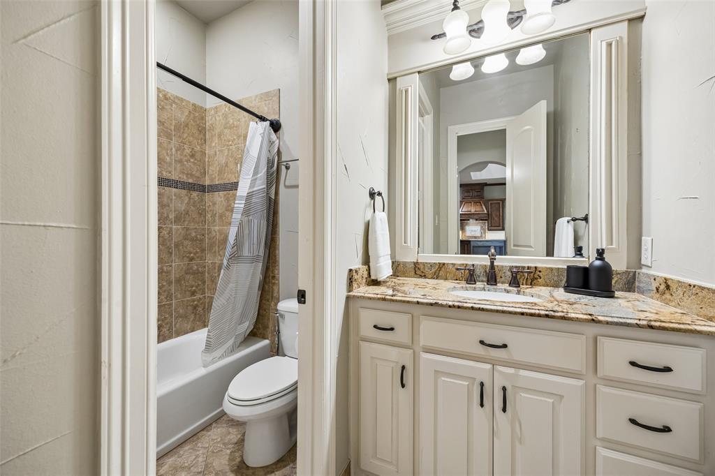 1608 Tuscan Ridge Circle Southlake, TX 76092 - Photo 21 of 36 a bathroom with a granite countertop sink toilet and shower
