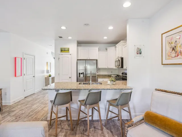 a large kitchen with a table and chairs