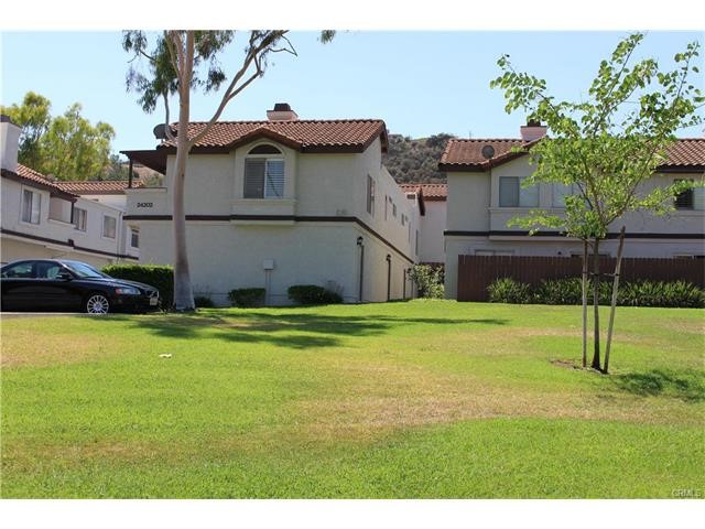 24202 Sylvan Glen Road, Unit F Diamond Bar, CA 91765 - Photo 2 of 8 a view of a house with a backyard and a palm tree