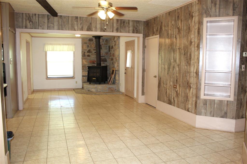 5050 Highway 67, Unit 377N Comanche, TX 76442 - Photo 11 of 30 a view of empty room with wooden floor and fan