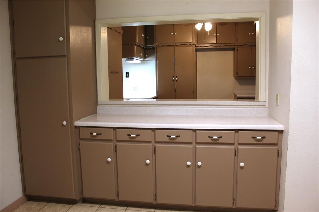 5050 Highway 67, Unit 377N Comanche, TX 76442 - Photo 20 of 30 a kitchen with a refrigerator and a sink