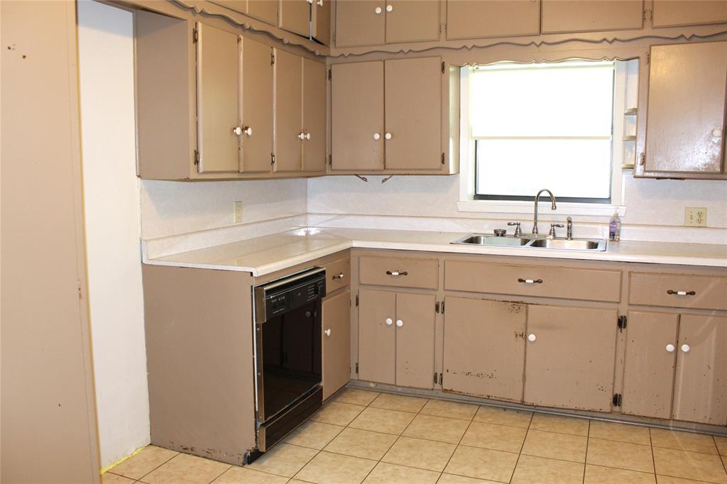 5050 Highway 67, Unit 377N Comanche, TX 76442 - Photo 8 of 30 a kitchen with a sink cabinets and window