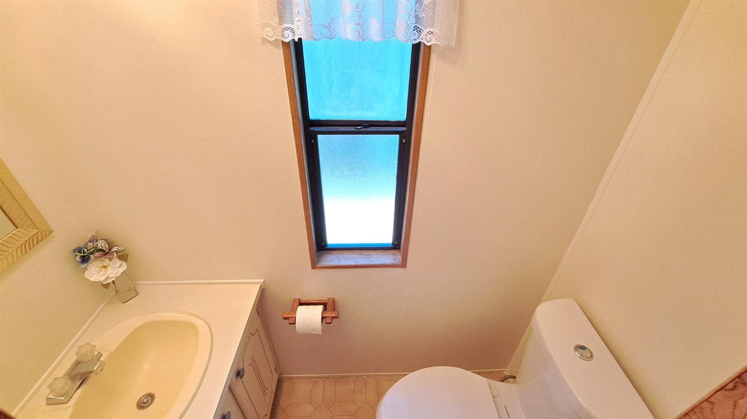 5766 Pony Express Trail, Unit 4 Pollock Pines, CA 95726 - Photo 15 of 17 a bathroom with a granite countertop sink and a mirror