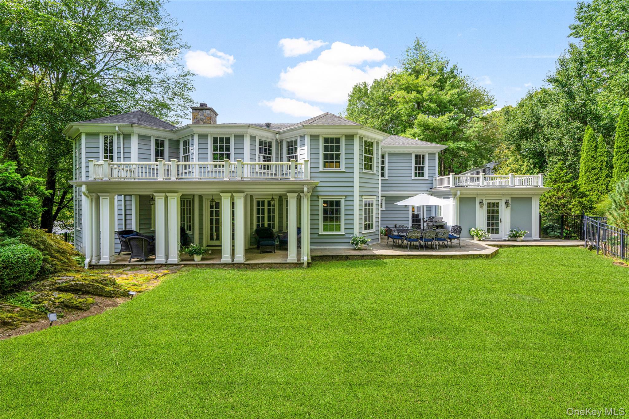 10 Hilltop Road Larchmont, NY 10538 - Photo 37 of 50 Back of the property with a patio, covered back porch overlooking the extensive back yard, and outdoor dining just off the kitchen