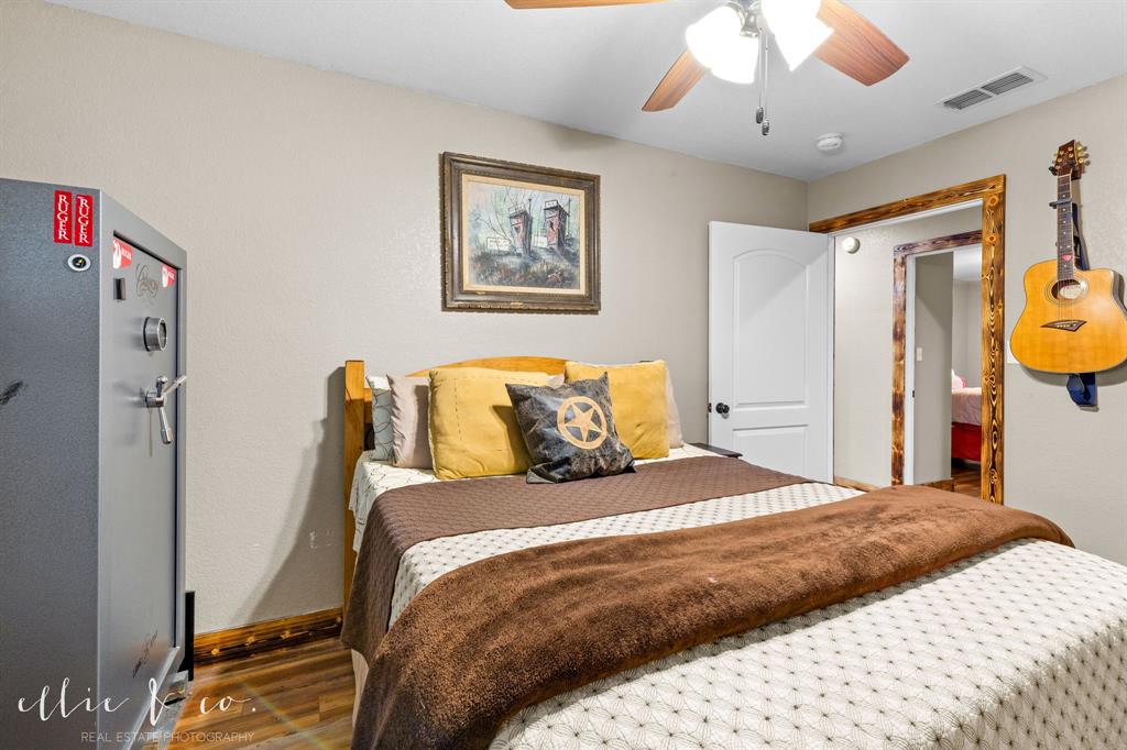 342 County Road 644 Merkel, TX 79536 - Photo 11 of 36 a bedroom with a bed and a chandelier