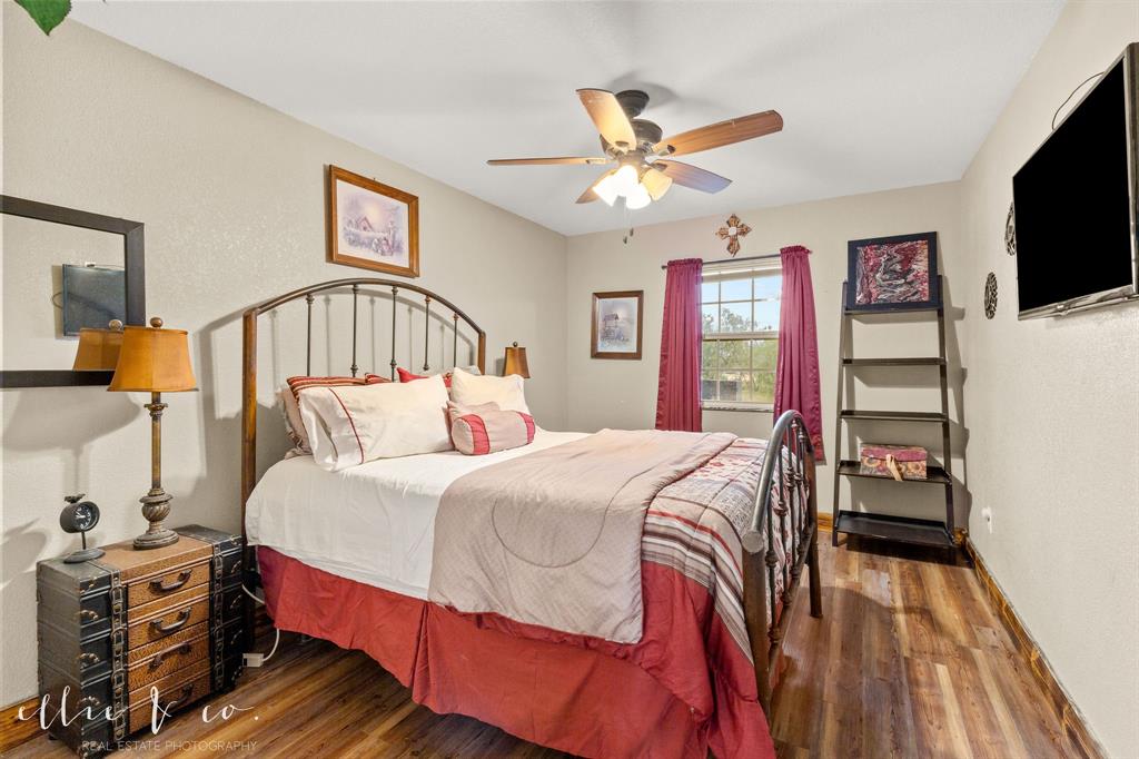 342 County Road 644 Merkel, TX 79536 - Photo 14 of 36 a bedroom with a bed and a flat tv screen on dresser