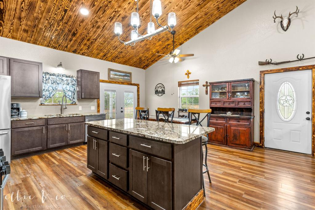 342 County Road 644 Merkel, TX 79536 - Photo 9 of 36 a kitchen with stainless steel appliances granite countertop a lot of counter space and wooden floors