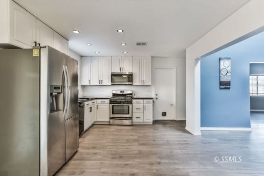 515 South Downs Street Ridgecrest, CA 93555 - Photo 9 of 31 a kitchen with a refrigerator oven a sink and dishwasher