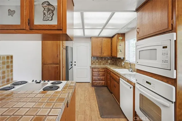 a kitchen with stainless steel appliances a stove sink and cabinets