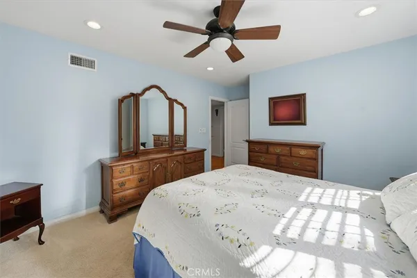 a bedroom with a bed and a television