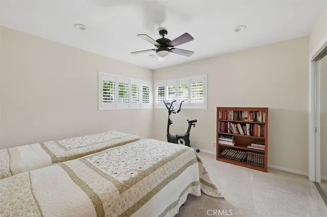 a bed room with a bed and a book shelf