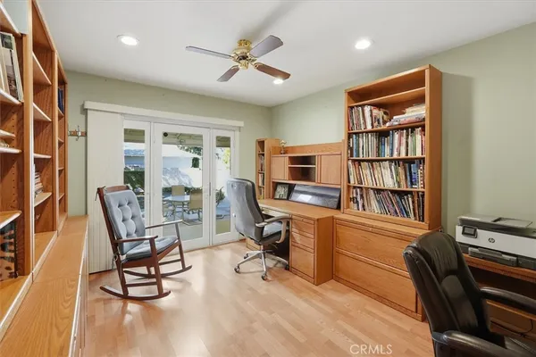 a view of a workspace with furniture and a bookshelf