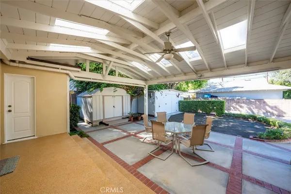 a view of a patio with a table and chairs