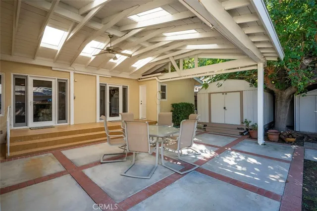 a view of a patio with table and chairs and potted plants