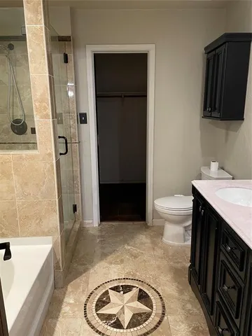 a bathroom with a sink a toilet a tub and a shower