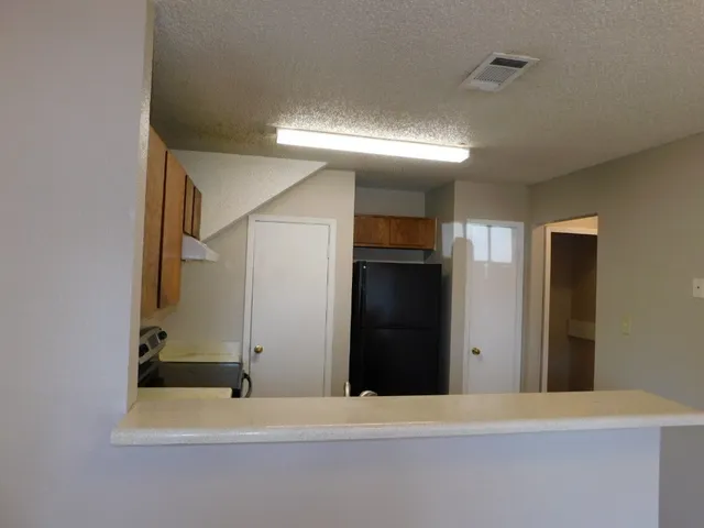 a kitchen with stainless steel appliances a refrigerator and a stove