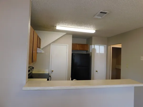 a kitchen with stainless steel appliances a refrigerator and a stove