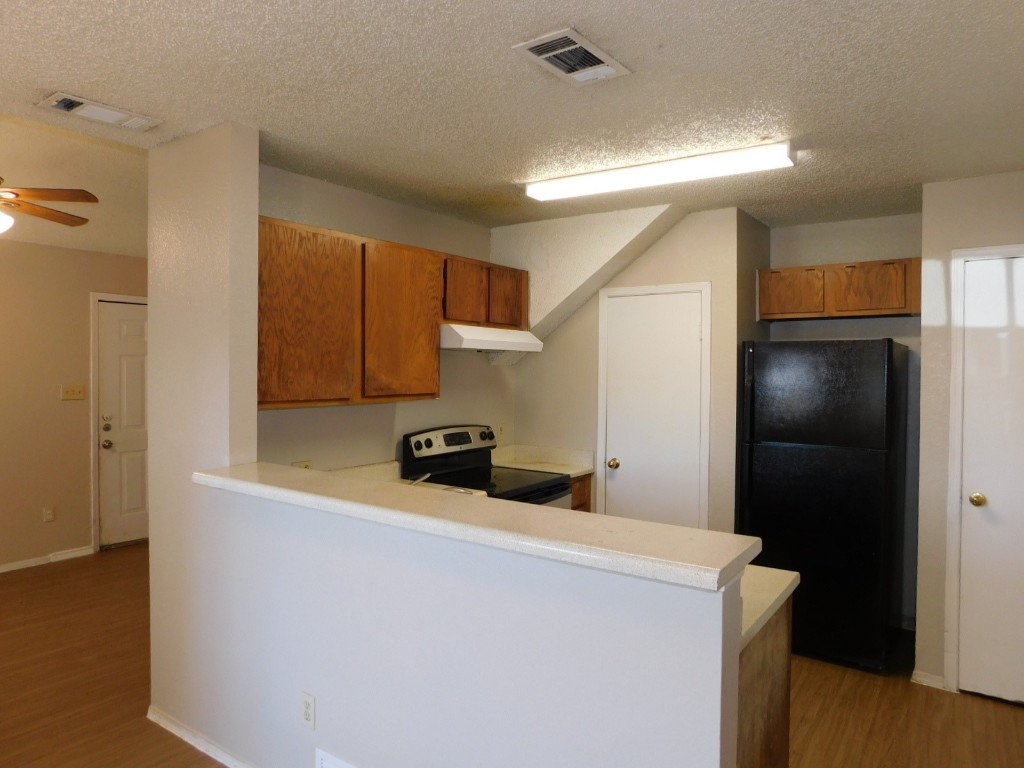 2223 Katy Lane, Unit B Georgetown, TX 78626 - Photo 5 of 11 a kitchen with stainless steel appliances a refrigerator and a stove