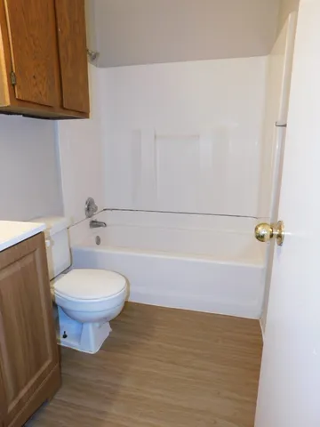 an empty room with a ceiling fan and window