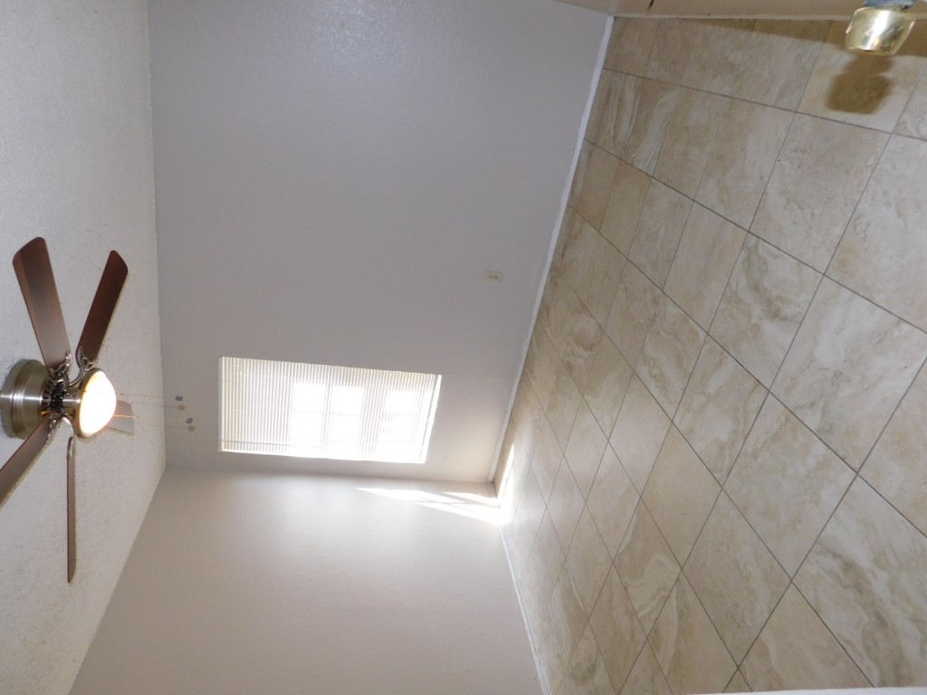 2223 Katy Lane, Unit B Georgetown, TX 78626 - Photo 7 of 11 an empty room with a ceiling fan and window