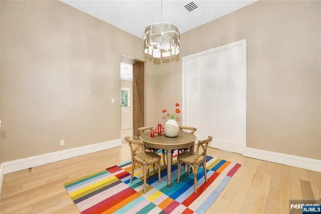 a view of a dining room with furniture and chandelier