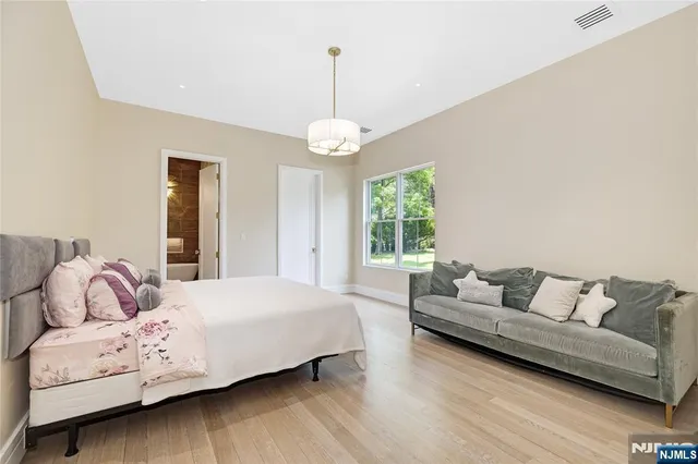 a bedroom with a bed and a couch