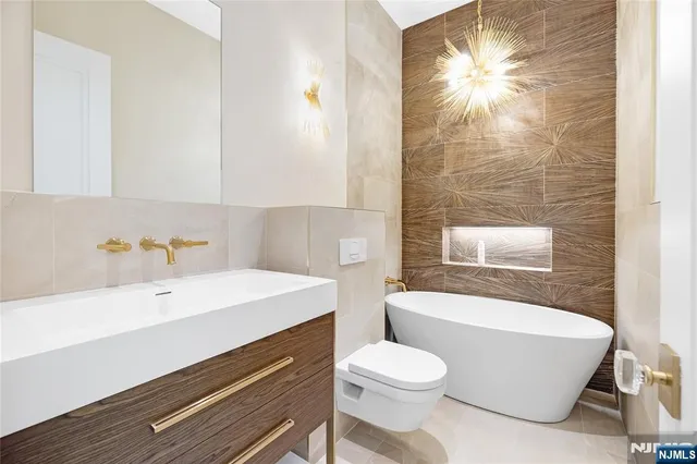 a bathroom with a sink a toilet and bathtub