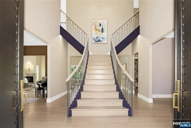 a view of staircase with lots of frames and a rug