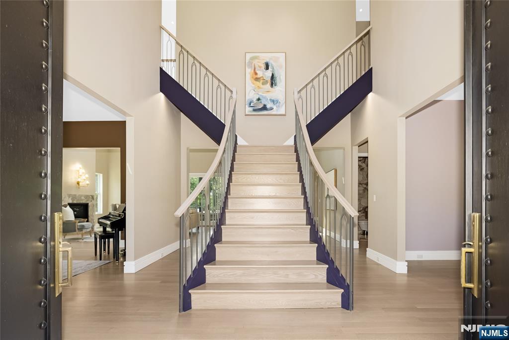 241 East Saddle River Road Saddle River, NJ 07458 - Photo 2 of 48 a view of staircase with lots of frames and a rug