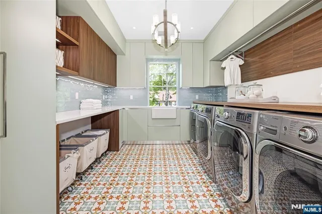a kitchen with a sink cabinets appliances and a window