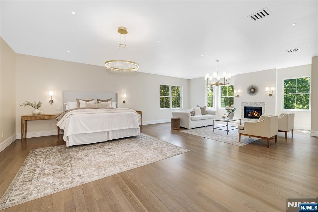 241 East Saddle River Road Saddle River, NJ 07458 - Photo 27 of 48 a spacious bedroom with a bed a couch and large window