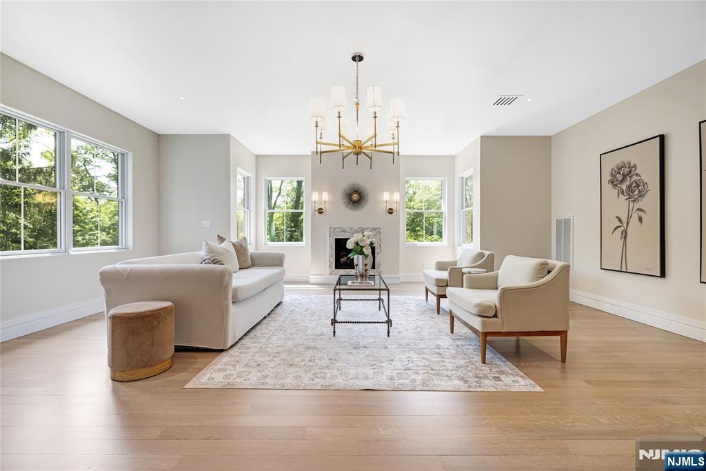 241 East Saddle River Road Saddle River, NJ 07458 - Photo 28 of 48 a living room with furniture a large window and a chandelier