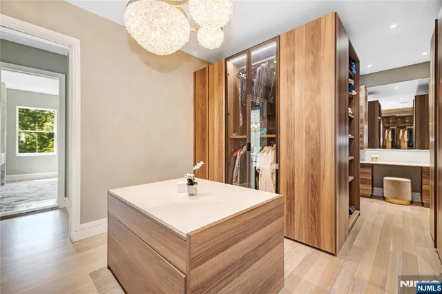 a en suite bathroom with a sink and a large mirror