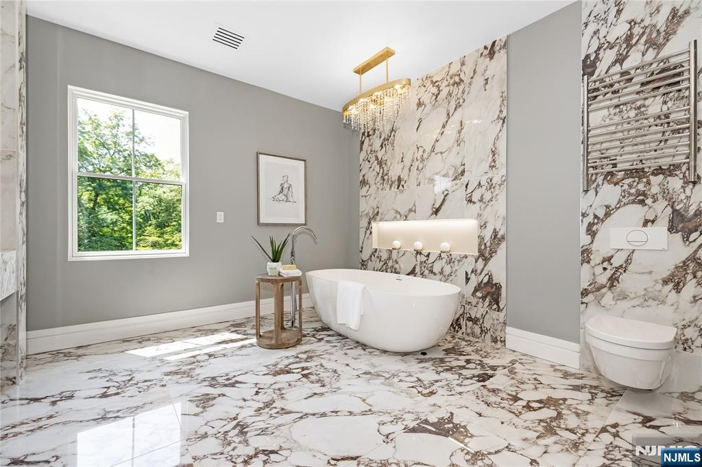 241 East Saddle River Road Saddle River, NJ 07458 - Photo 32 of 48 a living room with a couch and a table