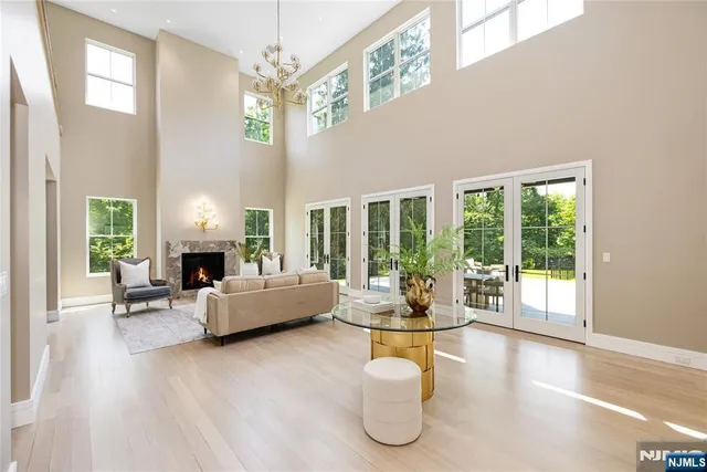 a living room with fireplace furniture and a large window