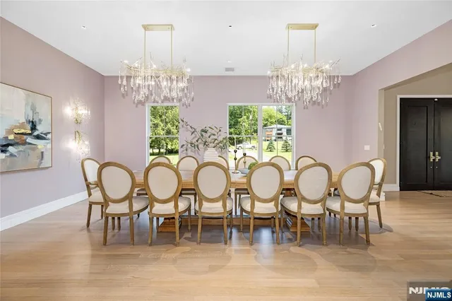a view of a dining room with furniture a chandelier and wooden floor