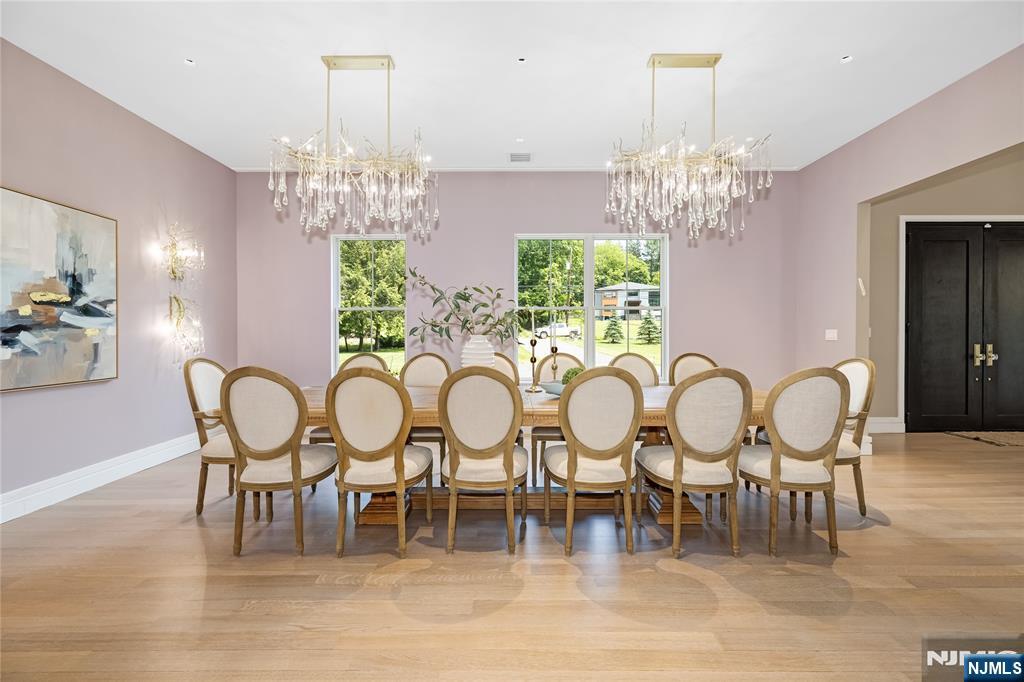 241 East Saddle River Road Saddle River, NJ 07458 - Photo 7 of 48 a view of a dining room with furniture a chandelier and wooden floor