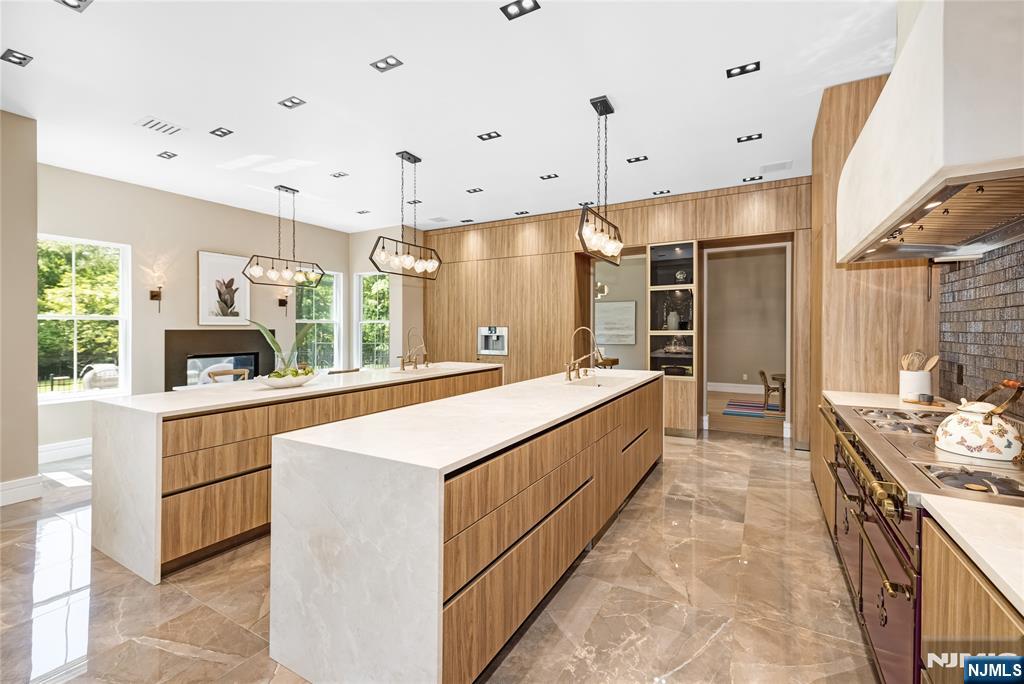 241 East Saddle River Road Saddle River, NJ 07458 - Photo 9 of 48 a large white kitchen with a large window and stainless steel appliances