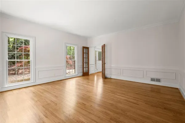 a kitchen with stainless steel appliances granite countertop a refrigerator a sink dishwasher and a stove with wooden floor