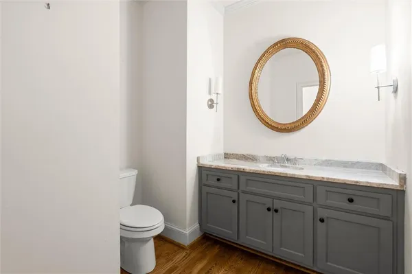 a bathroom with a granite countertop sink a large mirror and a bathtub