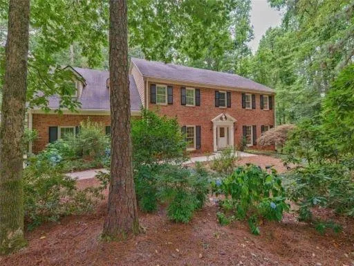 a view of a house with a backyard and windows